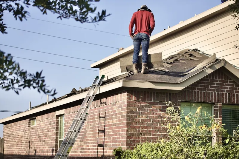 Professional roofer working on a residential roof in Marble Estates